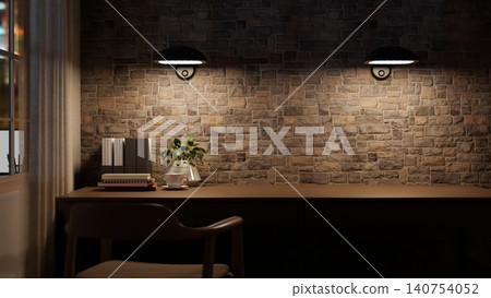Dim lit workspace with hanging lamps over book and coffee cup on long wooden table beside brick wall Dim lit workspace with hanging lamps over book and coffee cup on long wooden table beside brick wall 140754052