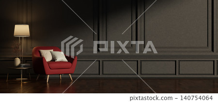 Red sofa armchair with cushion next to a standing lamp beside dark black paneled wall in modern room Red sofa armchair with cushion next to a standing lamp beside dark black paneled wall in modern room 140754064
