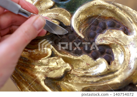 Detailed View of Decorative Wood Carving Showing Intricate Design With Dark and Light Colors in a Close Up Setting 140754072
