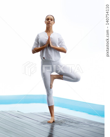 Yoga, relax and pool deck with balance, peace and calm by water with zen outdoor at home. Wellness, health and female person on a patio with namaste, pilates and spiritual practice with eyes closed Yoga, relax and pool deck with balance, peace and calm by water with zen outdoor at home. Wellness, health and female person on a patio with namaste, pilates and spiritual practice with eyes closed 140754110