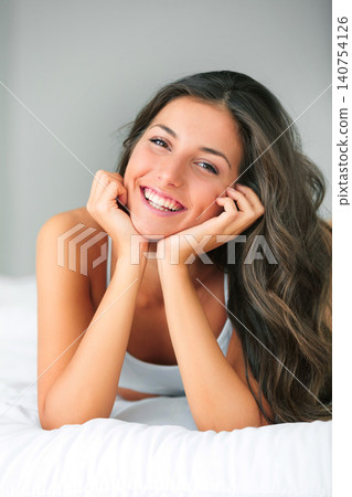 Happy, portrait and woman in bed with positive attitude, chilling or feel good mood at home. Morning, smile and face of female person in a bedroom resting, relax or enjoying a peaceful lazy day off 140754126