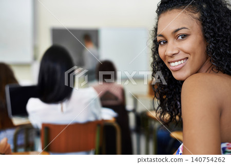 University, college and portrait of woman in classroom for learning, studying and knowledge. Education, academy and face of happy student in lecture for course, school work and writing exam on campus 140754262