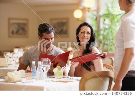 Couple, restaurant and menu with choice, lunch and love for anniversary or celebration. Woman, man and date with luxury, fine dining and smile for relationship on holiday or vacation with meal Couple, restaurant and menu with choice, lunch and love for anniversary or celebration. Woman, man and date with luxury, fine dining and smile for relationship on holiday or vacation with meal 140754336