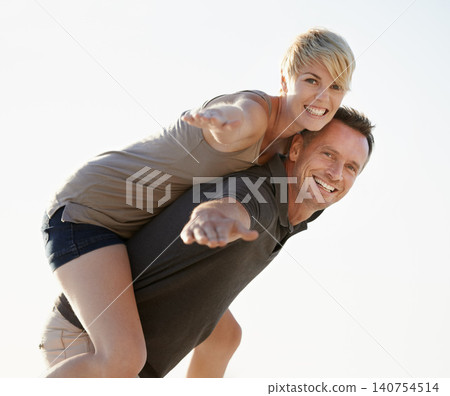 Couple, portrait and happy outdoor with piggyback for bonding, honeymoon date and weekend holiday. Face, man and woman with embrace, smile and love in California for vacation, travel and adventure 140754514