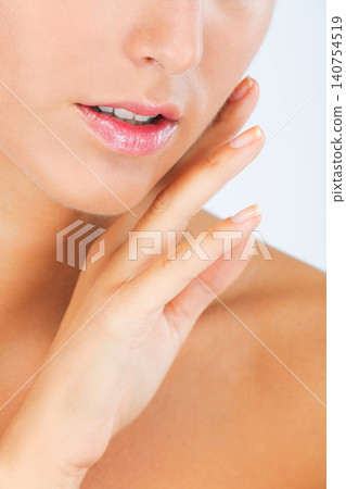 Face, lips and hand with woman touching skin for dermatology, beauty and moisturizer isolated on white background. Facial, balm for mouth with shine and cosmetic care, wellness and skincare in studio Face, lips and hand with woman touching skin for dermatology, beauty and moisturizer isolated on white background. Facial, balm for mouth with shine and cosmetic care, wellness and skincare in studio 140754519