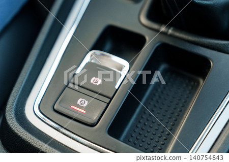 Electronic parking brake button in car interior Electronic parking brake button in car interior 140754843