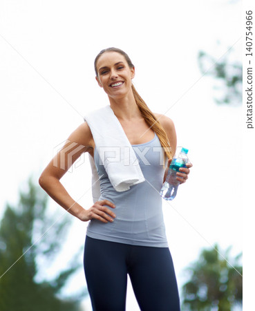 Woman, portrait and water bottle for fitness, workout and exercise outdoor with a smile and towel. Happy, training and female person with health, wellness and sport in nature with drink on a break Woman, portrait and water bottle for fitness, workout and exercise outdoor with a smile and towel. Happy, training and female person with health, wellness and sport in nature with drink on a break 140754966