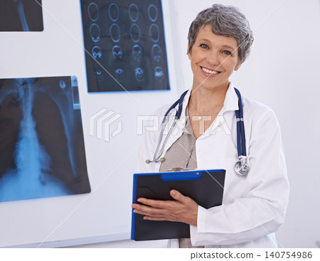 Doctor, woman and portrait with clipboard, radiology for surgery with anatomy scan and healthcare. Senior medical professional, treatment and surgeon in room for xray, checklist and confident expert Doctor, woman and portrait with clipboard, radiology for surgery with anatomy scan and healthcare. Senior medical professional, treatment and surgeon in room for xray, checklist and confident expert 140754986