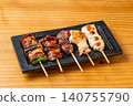 A juicy assortment of grilled chicken skewers, with the aroma of charcoal grilling that will whet your appetite. 140755790