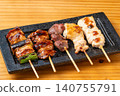A juicy assortment of grilled chicken skewers, with the aroma of charcoal grilling that will whet your appetite. 140755791