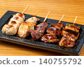 A juicy assortment of grilled chicken skewers, with the aroma of charcoal grilling that will whet your appetite. 140755792
