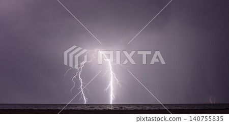 night shooting of a thunderstorm over the sea, photography of lightning 140755835