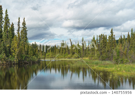 Canada's Yukon Territory: Stunning scenery of taiga forests and tranquil watersides spread across wetlands. A must-see tourist attraction. Canada's Yukon Territory: Stunning scenery of taiga forests and tranquil watersides spread across wetlands. A must-see tourist attraction. 140755956