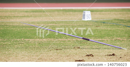 A javelin pegged into the turf, javelin speared into the ground	 140756023