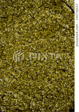 Traditional Italian basil pesto background top view Traditional Italian basil pesto background top view 140756037