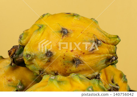 Group of whole raw exotic yellow pitahaya dragonfruits Group of whole raw exotic yellow pitahaya dragonfruits 140756042