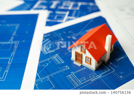 House figurine on blueprints drawings with landscape design schemes. Building renovation and reconstruction project. Facade insulation, energy efficiency improvement and property maintenance. House figurine on blueprints drawings with landscape design schemes. Building renovation and reconstruction project. Facade insulation, energy efficiency improvement and property maintenance. 140756136
