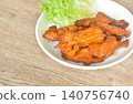 roasted spicy barbecue chicken rib with pepper on plate eat couple fresh lettuce vegetable salad 140756740