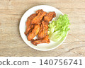 roasted spicy barbecue chicken rib with pepper on plate eat couple fresh lettuce vegetable salad 140756741