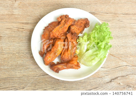 roasted spicy barbecue chicken rib with pepper on plate eat couple fresh lettuce vegetable salad 140756741
