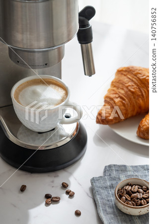 Breakfast with croissants and cappuccino from an espresso machine in a cozy, homely atmosphere. Breakfast with croissants and cappuccino from an espresso machine in a cozy, homely atmosphere. 140756852