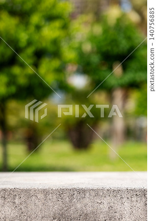 Empty concrete surface with blurred green park background and copy space 140756885