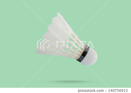 Badminton shuttlecock floating on green background Badminton shuttlecock floating on green background 140756915
