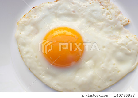 Fried egg on white dish close up 140756958