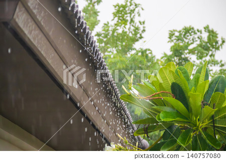 rain falling down from the house roof rain falling down from the house roof 140757080