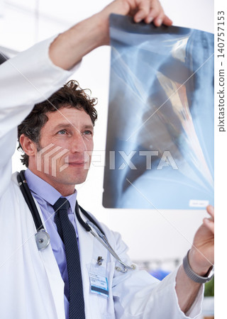 Doctor, man and xray in hospital for reading results with thinking for lungs, decision or healthcare. Professional medic, check and film paper for respiratory system exam for asthma with radiology Doctor, man and xray in hospital for reading results with thinking for lungs, decision or healthcare. Professional medic, check and film paper for respiratory system exam for asthma with radiology 140757153