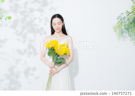 Woman with a bouquet of sunflowers Woman with a bouquet of sunflowers 140757271