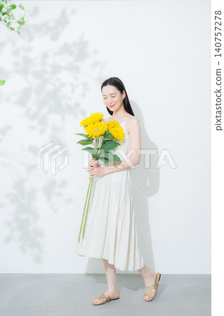Woman with a bouquet of sunflowers Woman with a bouquet of sunflowers 140757278