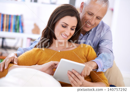 Couple, internet and smile with tablet on sofa with hug for bonding, love and relax with social media or web scroll. Senior man, woman and happy with technology for subscription and embrace in home Couple, internet and smile with tablet on sofa with hug for bonding, love and relax with social media or web scroll. Senior man, woman and happy with technology for subscription and embrace in home 140757292