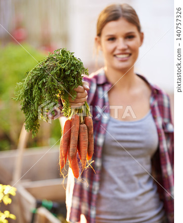 Happy woman, portrait and harvest with carrots for garden or farming of crops and resources. Female person with smile and a bunch of roots or organic vegetables for natural growth or fresh produce Happy woman, portrait and harvest with carrots for garden or farming of crops and resources. Female person with smile and a bunch of roots or organic vegetables for natural growth or fresh produce 140757326