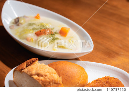Freshly baked bread, croquettes, and cream stew served on a plate. Freshly baked bread, croquettes, and cream stew served on a plate. 140757330
