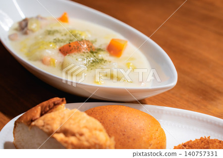 Bread and croquettes arranged on a plate, with a blurred background of stew. Bread and croquettes arranged on a plate, with a blurred background of stew. 140757331