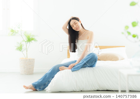 A woman relaxing in the bedroom A woman relaxing in the bedroom 140757386