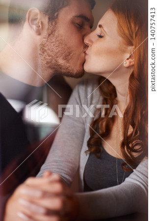 Happy couple, kiss and love with intimacy for embrace, support or affection together at indoor cafe. Man and woman holding hands and bonding on date for relationship or anniversary at the coffee shop Happy couple, kiss and love with intimacy for embrace, support or affection together at indoor cafe. Man and woman holding hands and bonding on date for relationship or anniversary at the coffee shop 140757413