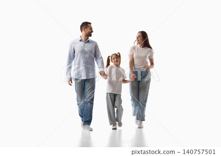 Family walking hand in hand on white studio background. Family walking hand in hand on white studio background. 140757501
