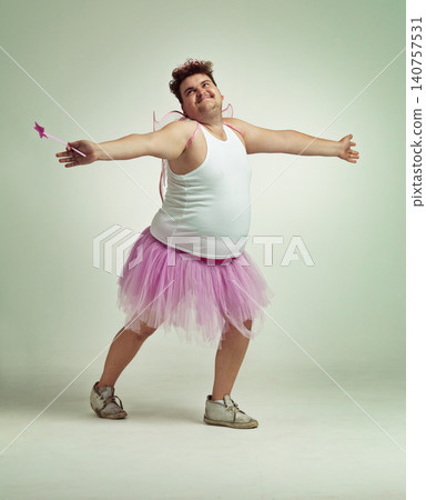Fairy, man and studio for magic and isolated, happy male person with wings and pretend costume. Pink Cosplay, fun and plus size model, dress up or play on white background for halloween on backdrop Fairy, man and studio for magic and isolated, happy male person with wings and pretend costume. Pink Cosplay, fun and plus size model, dress up or play on white background for halloween on backdrop 140757531