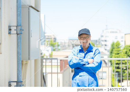 Senior citizen inspecting outdoor air conditioning units on the rooftop of an office building. Senior citizen inspecting outdoor air conditioning units on the rooftop of an office building. 140757560