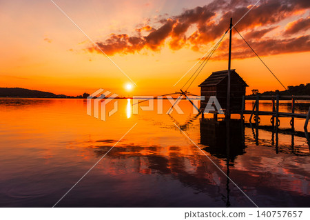 The tranquil evening view of Lake Togo, bathed in the colors of the setting sun. The tranquil evening view of Lake Togo, bathed in the colors of the setting sun. 140757657