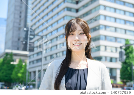 Japanese woman standing in a city of skyscrapers Japanese woman standing in a city of skyscrapers 140757929