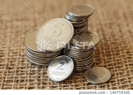 Heap of Ukrainian coins on burlap close up Heap of Ukrainian coins on burlap close up 140759100