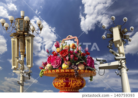 Street lamp and huge flower basket (against the background of a beautiful sky with clouds) in Tiananmen square, Beijing, China Street lamp and huge flower basket (against the background of a beautiful sky with clouds) in Tiananmen square, Beijing, China 140759393