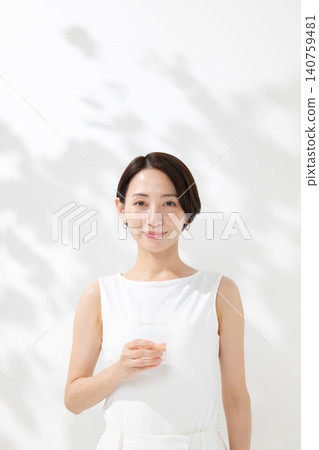 A woman drinking water A woman drinking water 140759481