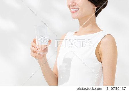 A woman drinking water A woman drinking water 140759487