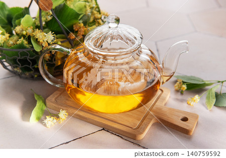 Linden blossoms herbal tea in glass teapot Linden blossoms herbal tea in glass teapot 140759592