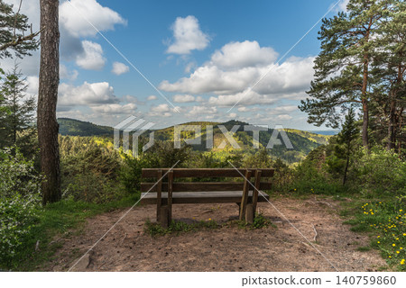 Wooden bench with scenic view over the  hills of the Palatinate Forest, Germany 140759860
