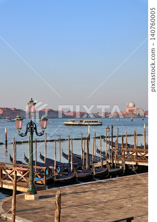Venice, Italy: Early morning in the San Marco district, with gondolas lined up along the lagoon. Venice, Italy: Early morning in the San Marco district, with gondolas lined up along the lagoon. 140760005
